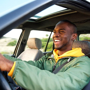 man smiling while driving