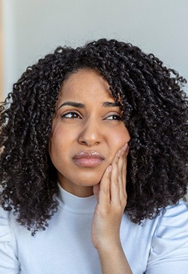 Woman experiencing toothache at home