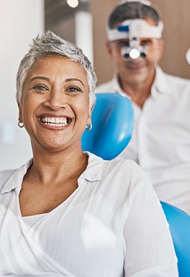 Woman smiling while sitting in treatment chair