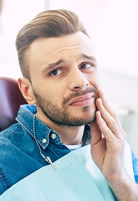 Patient with toothache looking at dentist