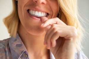 Woman putting on her Invisalign tray